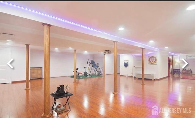 exercise area with wood finished floors and recessed lighting