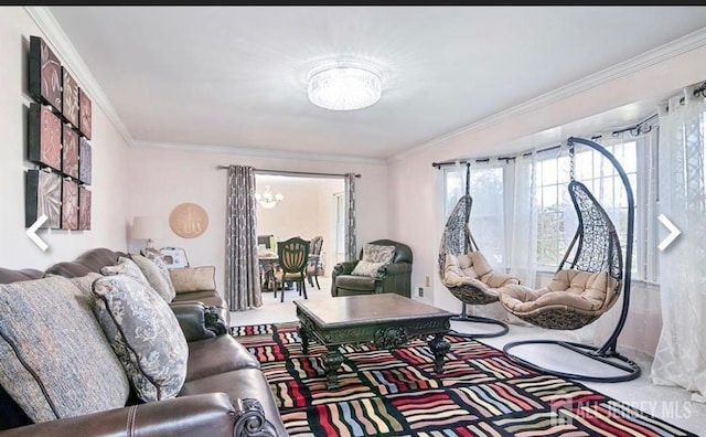 living room featuring ornamental molding and a chandelier