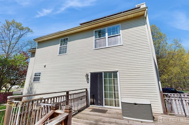 back of house featuring a wooden deck