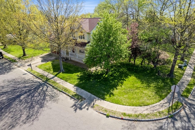 exterior space featuring a lawn and driveway