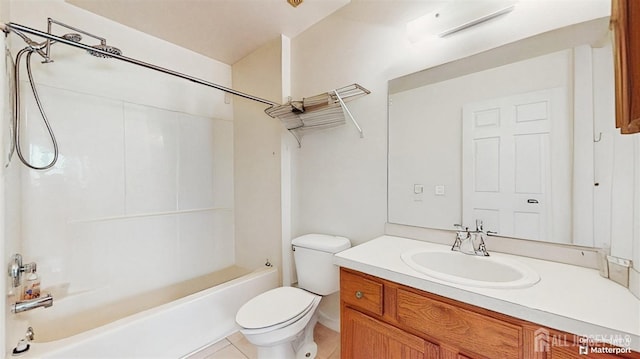 bathroom featuring vanity, tile patterned flooring, washtub / shower combination, and toilet