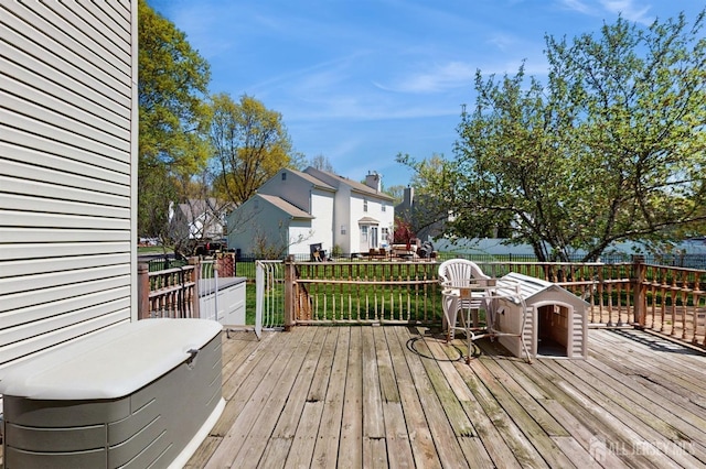 wooden deck featuring a yard