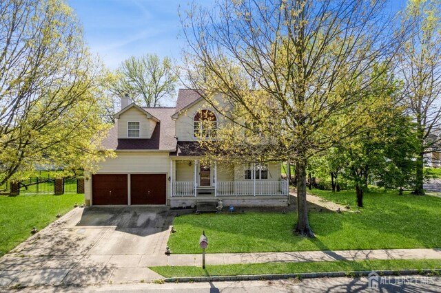 9 Keith Ln, Burlington Twp, NJ 08016 - view of front of property with covered porch, a garage, driveway, and a front lawn