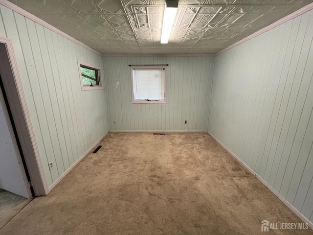 unfurnished room with light colored carpet and crown molding