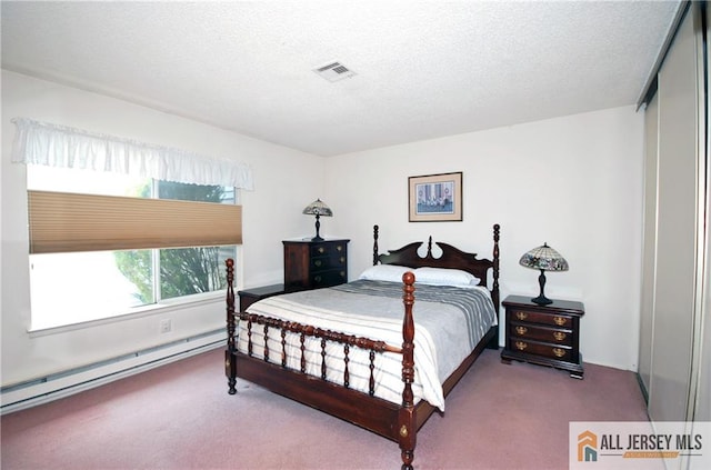 398 Fuchsia Plz Unit C, Monroe, NJ 08831 - carpeted bedroom featuring a baseboard radiator, visible vents, and a textured ceiling