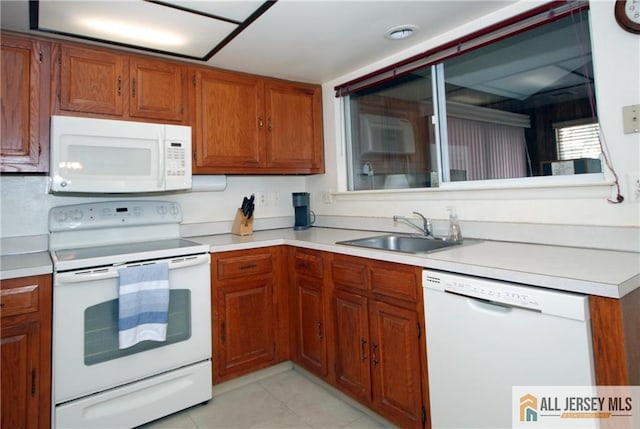 398 Fuchsia Plz Unit C, Monroe, NJ 08831 - kitchen with light countertops, brown cabinetry, a sink, and white appliances
