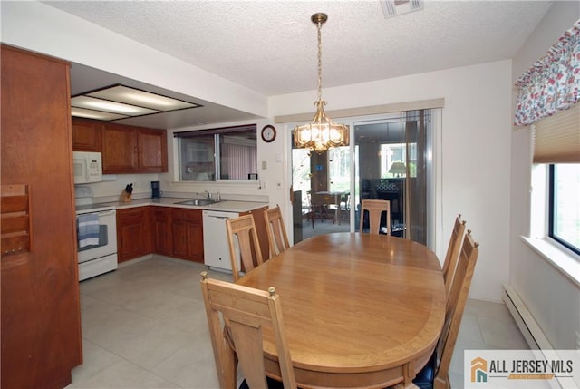 398 Fuchsia Plz Unit C, Monroe, NJ 08831 - dining area featuring a textured ceiling, light tile patterned flooring, visible vents, baseboard heating, and a notable chandelier