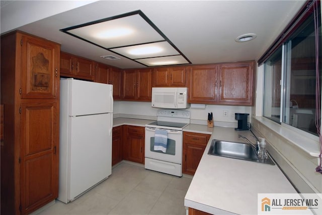 398 Fuchsia Plz Unit C, Monroe, NJ 08831 - kitchen featuring light countertops, brown cabinets, a sink, and white appliances