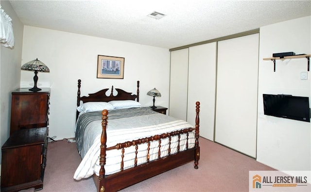398 Fuchsia Plz Unit C, Monroe, NJ 08831 - carpeted bedroom with a closet, visible vents, and a textured ceiling