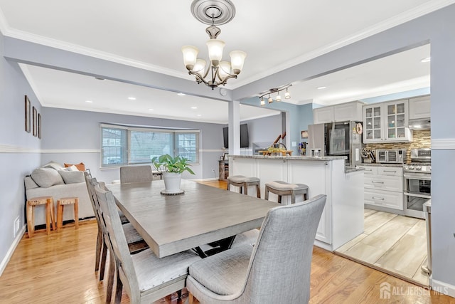 29 Dumas Rd, Old Bridge, NJ 08857 - dining space with a chandelier, light wood-style floors, and ornamental molding