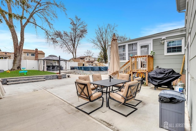 29 Dumas Rd, Old Bridge, NJ 08857 - fenced backyard with a gazebo, outdoor dining area, a patio, area for grilling, and a residential view