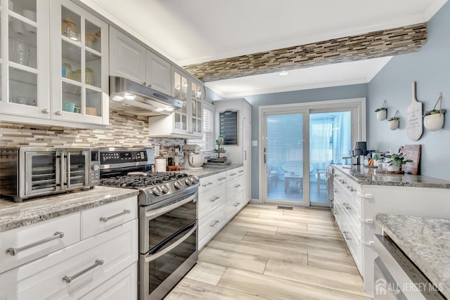29 Dumas Rd, Old Bridge, NJ 08857 - kitchen featuring double oven range, under cabinet range hood, crown molding, decorative backsplash, and healthy amount of natural light