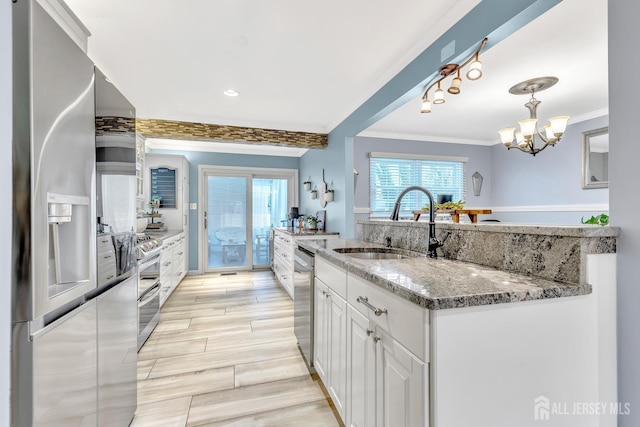 29 Dumas Rd, Old Bridge, NJ 08857 - kitchen with appliances with stainless steel finishes, crown molding, white cabinetry, plenty of natural light, and light stone countertops
