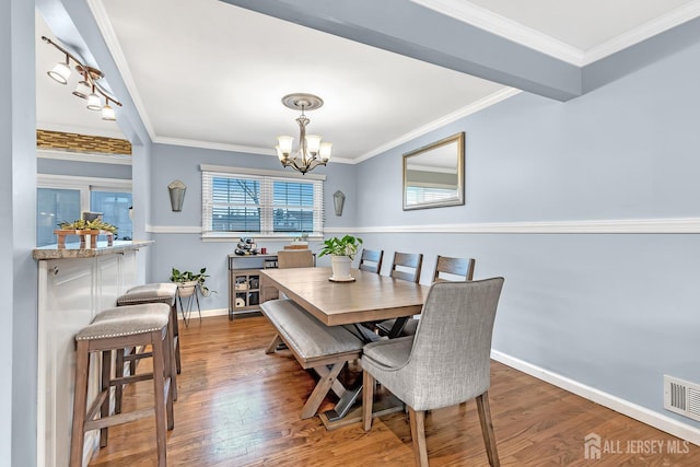 29 Dumas Rd, Old Bridge, NJ 08857 - dining room with a chandelier, wood finished floors, and ornamental molding