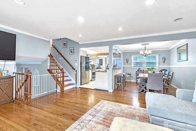 29 Dumas Rd, Old Bridge, NJ 08857 - living room featuring light wood-style flooring, crown molding, a chandelier, recessed lighting, and stairs