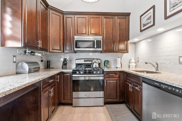 21 Haug St, Union Beach, NJ 07735 - kitchen featuring appliances with stainless steel finishes, a sink, tasteful backsplash, and light stone countertops