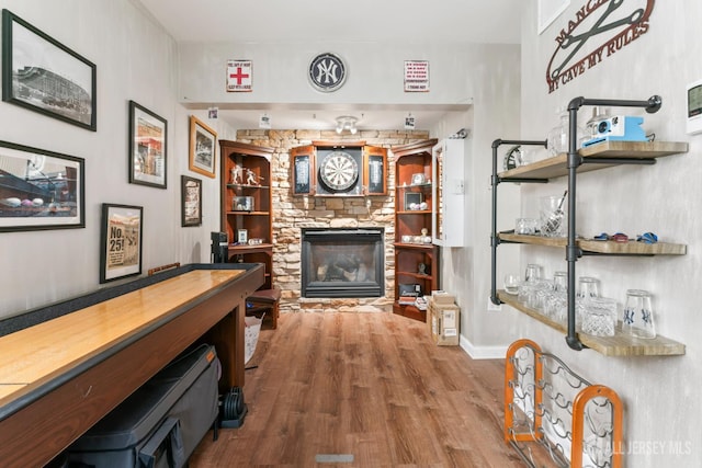 21 Haug St, Union Beach, NJ 07735 - living area featuring wood finished floors, a stone fireplace, built in features, and baseboards