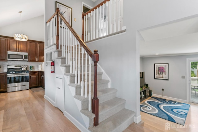 21 Haug St, Union Beach, NJ 07735 - staircase with wood finished floors, a high ceiling, baseboards, and recessed lighting