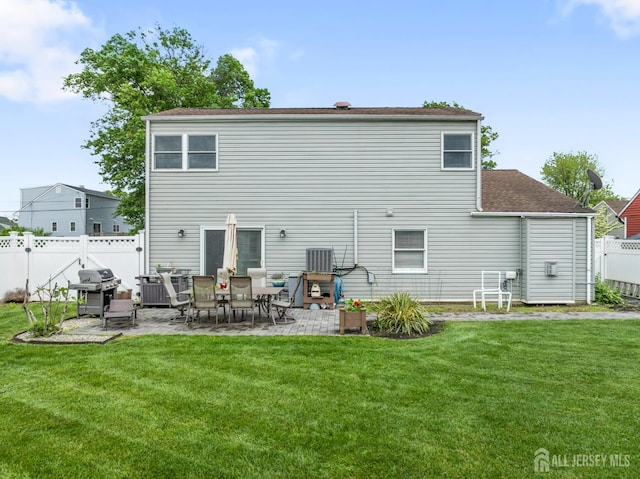 21 Haug St, Union Beach, NJ 07735 - back of property with a patio and roof with shingles