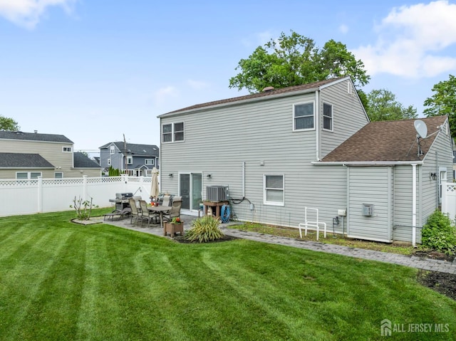 21 Haug St, Union Beach, NJ 07735 - back of house featuring a patio area, central AC unit, and roof with shingles