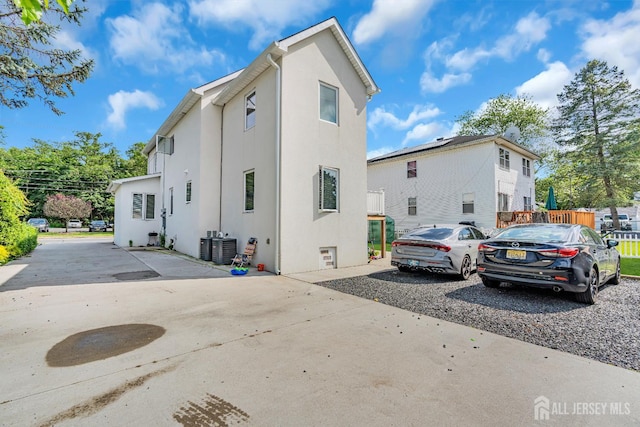 176 Main St, East Brunswick, NJ 08816 - view of side of home featuring stucco siding