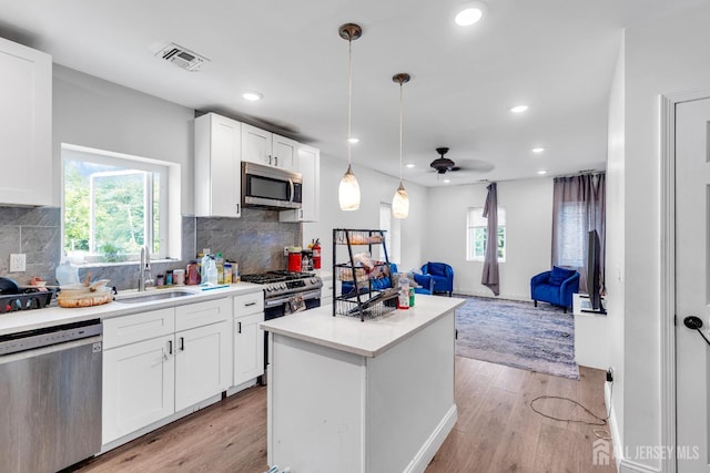 176 Main St, East Brunswick, NJ 08816 - kitchen with stainless steel appliances, recessed lighting, a kitchen island, light wood-style flooring, and open floor plan