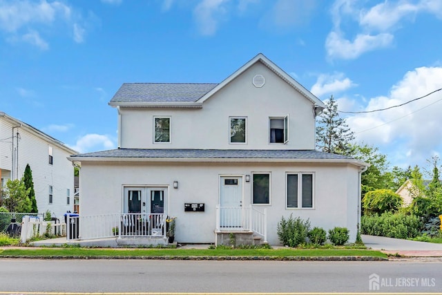 176 Main St, East Brunswick, NJ 08816 - view of front of property with stucco siding and a shingled roof