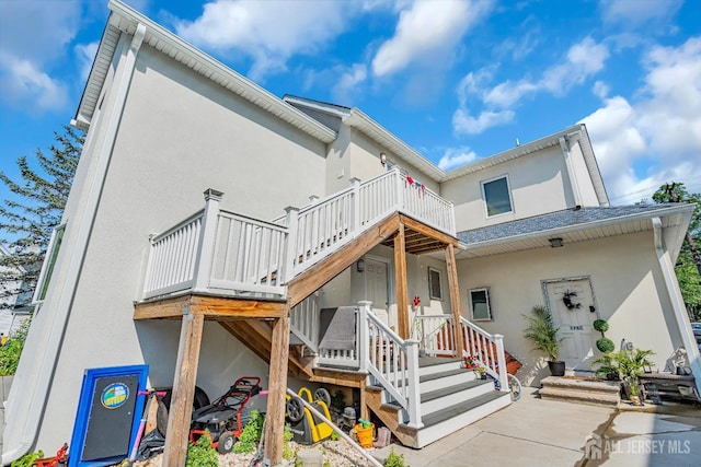 176 Main St, East Brunswick, NJ 08816 - back of property featuring stucco siding and a wooden deck
