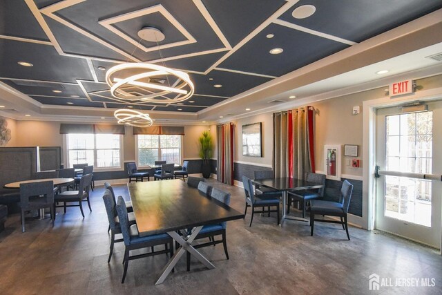 dining area with a raised ceiling and an inviting chandelier