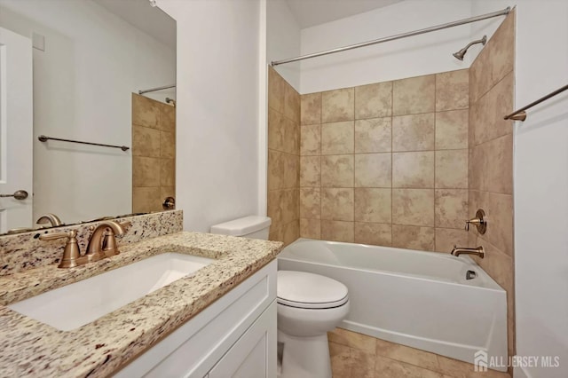 full bathroom featuring tile patterned floors, tiled shower / bath combo, toilet, and vanity