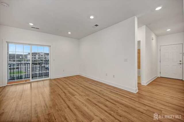 spare room with light hardwood / wood-style flooring