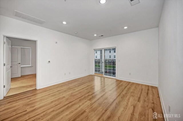 spare room with light wood-type flooring