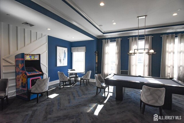 dining room featuring dark parquet flooring, billiards, and a tray ceiling