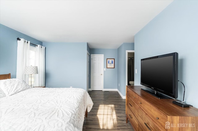 bedroom with dark hardwood / wood-style floors