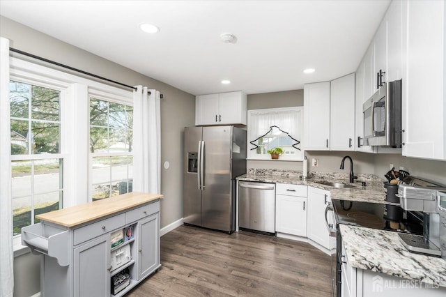 kitchen featuring white cabinetry, appliances with stainless steel finishes, and sink