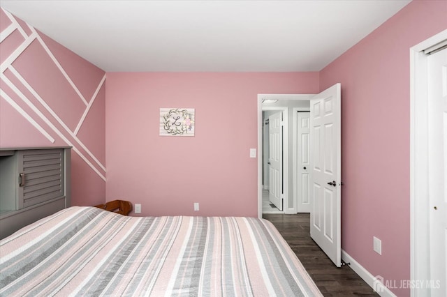 unfurnished bedroom featuring dark hardwood / wood-style floors and a closet