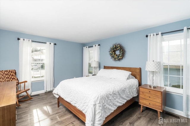 bedroom with dark wood-type flooring