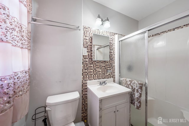 21 Coolidge Ave, East Brunswick, NJ 08816 - bathroom with a stall shower, vanity, toilet, and tile walls