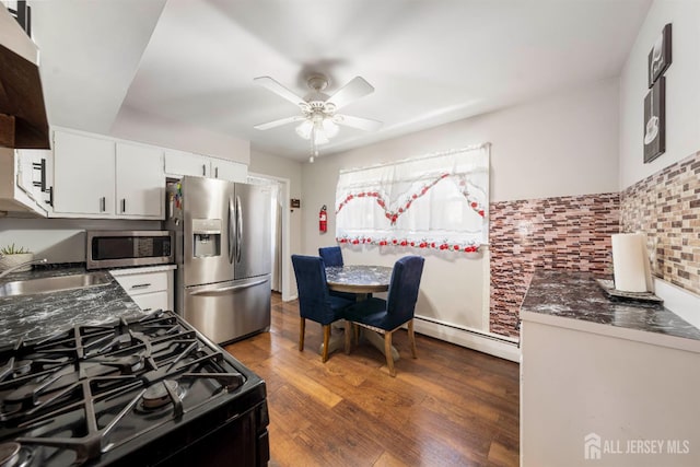 21 Coolidge Ave, East Brunswick, NJ 08816 - kitchen featuring stainless steel appliances, a sink, a baseboard heating unit, white cabinets, and ceiling fan