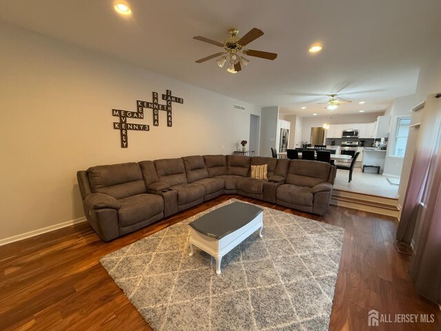 living room with a ceiling fan, dark wood finished floors, recessed lighting, and baseboards