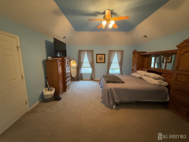 bedroom with light carpet, lofted ceiling, baseboards, and ceiling fan
