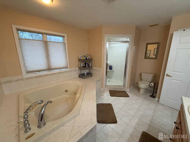 full bathroom featuring tile patterned flooring, vanity, shower with separate bathtub, and toilet