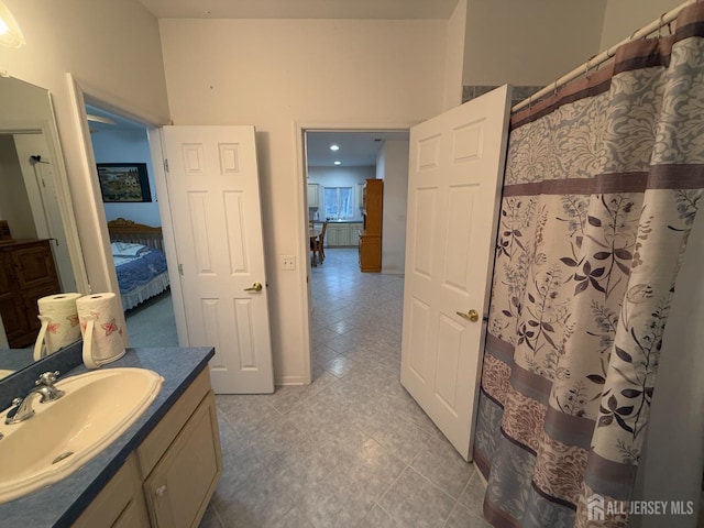 bathroom featuring vanity and curtained shower