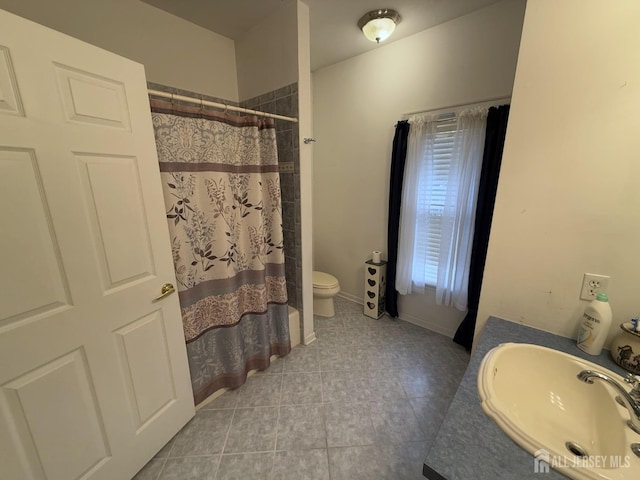 full bathroom with a sink, tile patterned flooring, toilet, and a shower with shower curtain