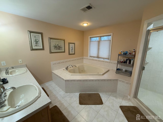 bathroom with tile patterned floors, vanity, and independent shower and bath