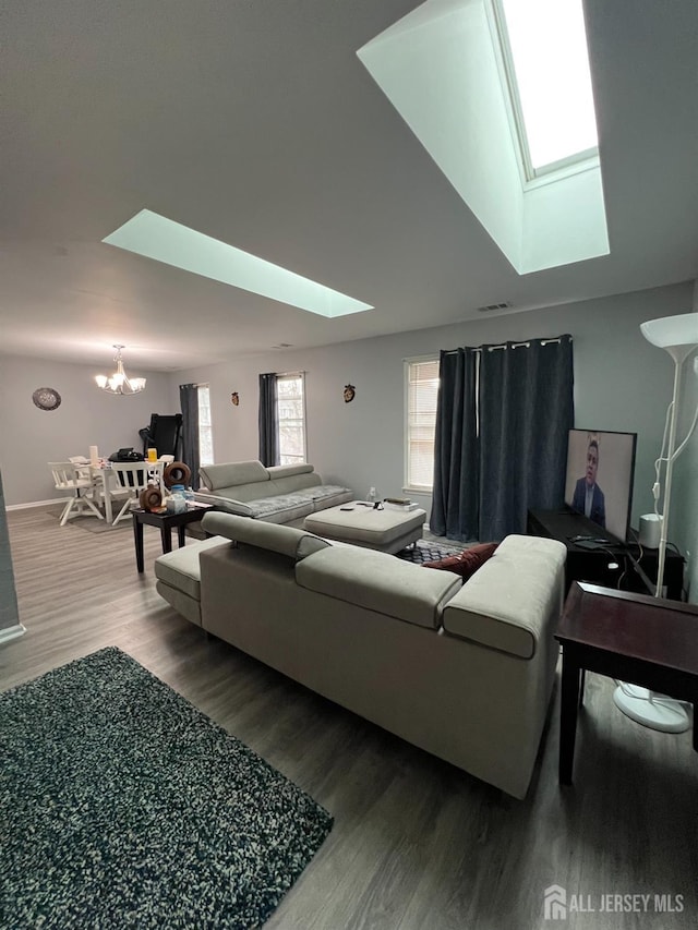 354 Burdock Ct, Readington, NJ 08887 - living area featuring a skylight, a chandelier, wood finished floors, and baseboards
