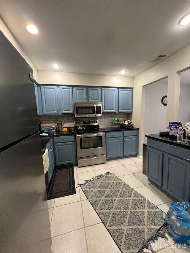 354 Burdock Ct, Readington, NJ 08887 - kitchen featuring stainless steel appliances, decorative backsplash, light tile patterned floors, blue cabinets, and recessed lighting