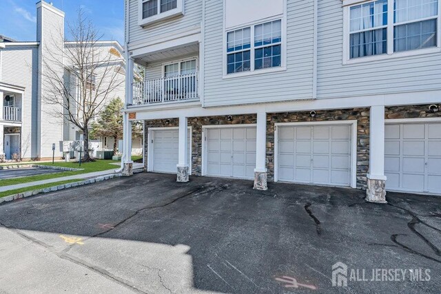 46 Prestwick Way, Edison, NJ 08820 - view of home's exterior featuring stone siding and an attached garage
