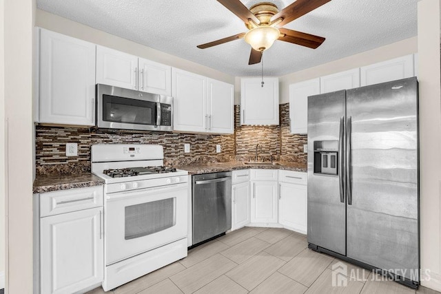 46 Prestwick Way, Edison, NJ 08820 - kitchen with stainless steel appliances, white cabinets, ceiling fan, a sink, and backsplash