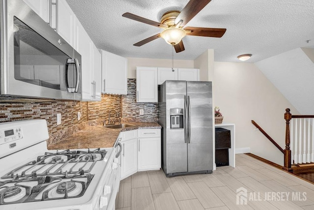 46 Prestwick Way, Edison, NJ 08820 - kitchen featuring appliances with stainless steel finishes, a sink, decorative backsplash, ceiling fan, and white cabinetry